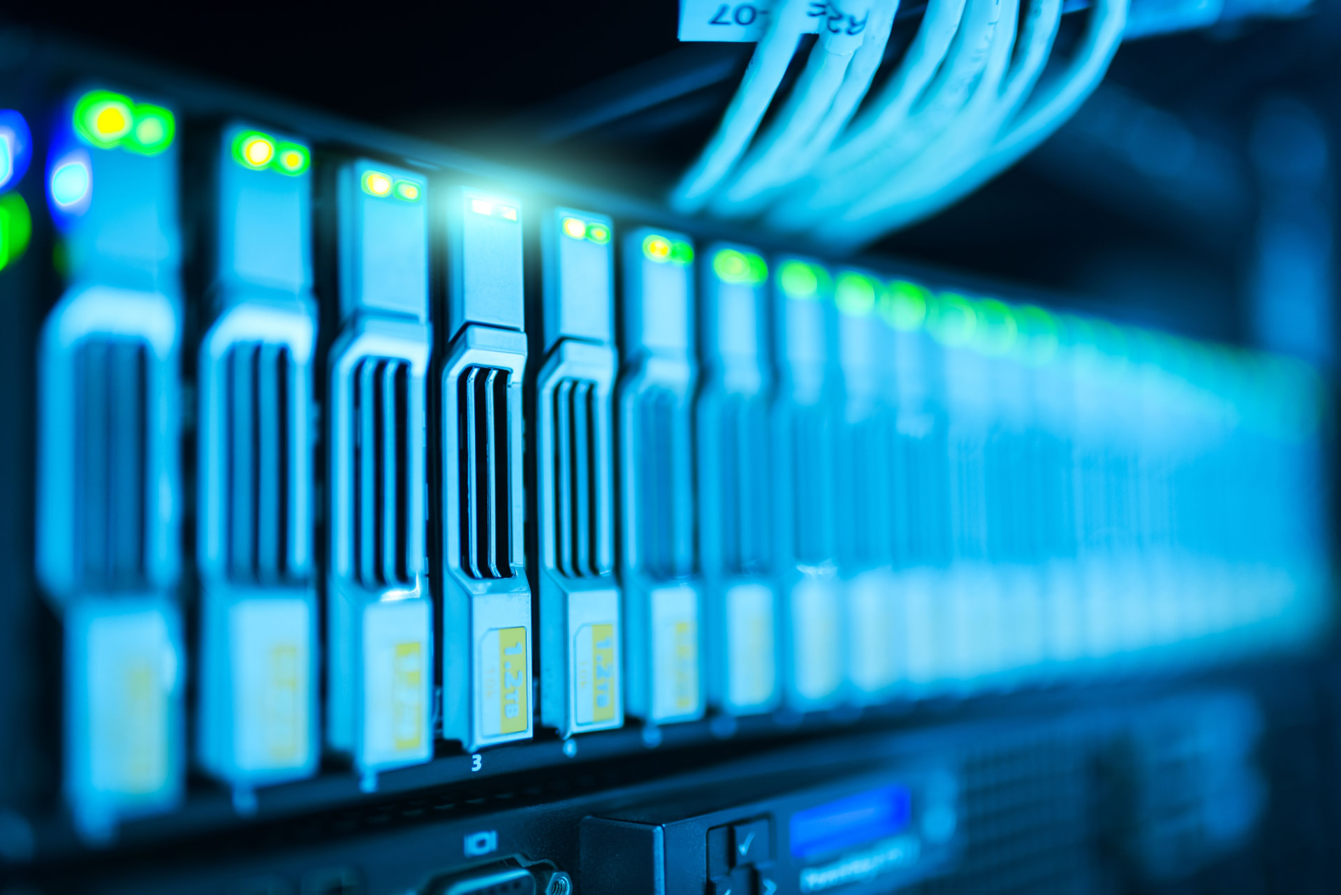 Illuminated data-centre server equipment and network cables.